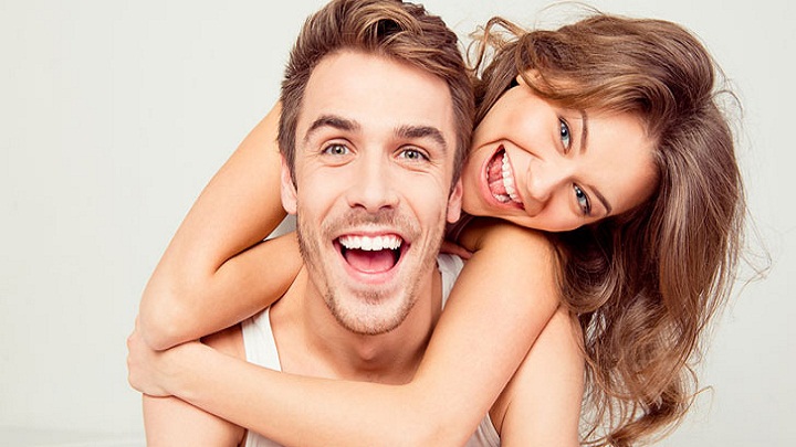 Cheerful Smiling Couple In Love Hugging In The Bedroom