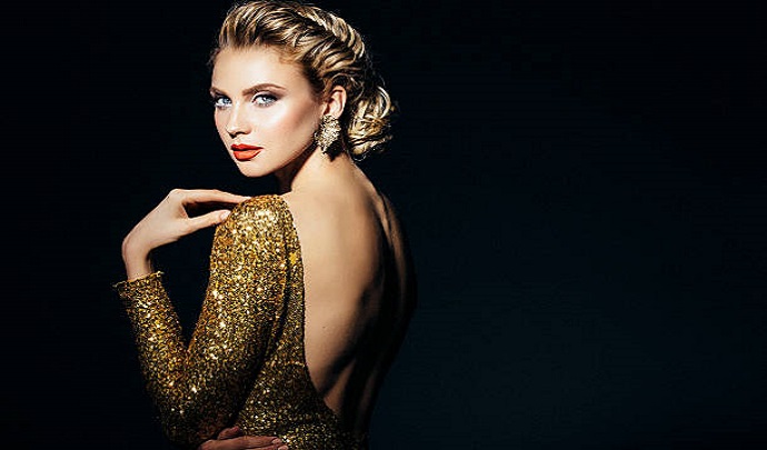 Studio shot of young beautiful woman with earings haute couture. Professional make-up and hairstyle