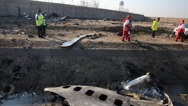 epa08111550 Emergency services personnel walk amidst the wreckage after an Ukraine International Airlines Boeing 737-800 carrying 176 people crashed near Imam Khomeini Airport in Tehran, killing everyone on board; in Shahriar, Iran, 08 January 2020.  EPA-EFE/ABEDIN TAHERKENAREH
