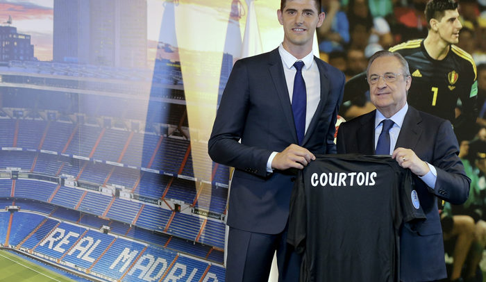 Belgian new Real Madrid soccer player Thibaut Courtois, left, and Real Madrid President Florentino Perez pose for the media during his official presentation for Real Madrid at the Santiago Bernabeu stadium in Madrid, Thursday, Aug. 9, 2018. Chelsea has sold a player — goalkeeper Thibaut Courtois — to Real Madrid. The Belgian was replaced by Kepa Arrizabalaga after Chelsea met the goalkeeper's 80 million euro ($93 million) buyout clause from Athletic Bilbao on Wednesday. (AP Photo/Andrea Comas)