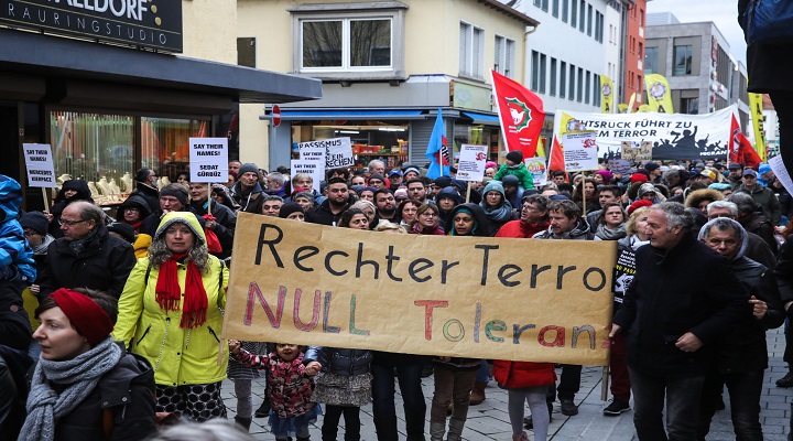 epa08237696 People hold banners as they protest against the racist terror attack in Hanau, Germany, 22 February 2020. At least nine people were killed on 19 February 2020 in two shootings at shisha bars in Hanau, police said. The perpetrator, a suspected far-right extremist, was reportedly found dead later at his home along with the body of his mother.  EPA-EFE/ARMANDO BABANI