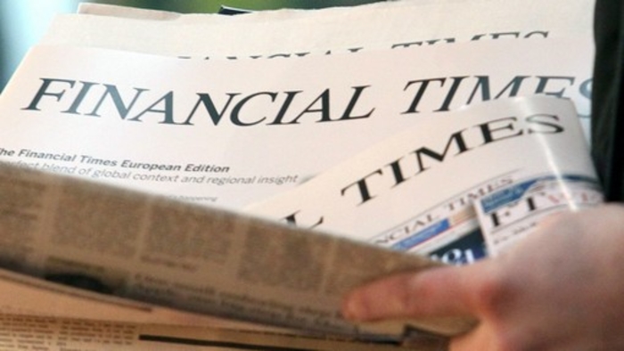 Copies of the English edition of the Financial Times are handed out at the central station in Hamburg, Germany, 07 December 2012. After 13 years, the FTD sells its final issue. Photo: Bodo Marks