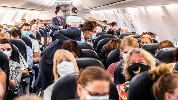 Passengers are welcomed on a Corendon plane departing from Amsterdam's Schiphol airport to Bulgaria's Burgas airport, on June 26, 2020, on the first holiday flight by the travel company since the novel coronavirus in March. (Photo by Jeffrey GROENEWEG / ANP / AFP) / Netherlands OUT