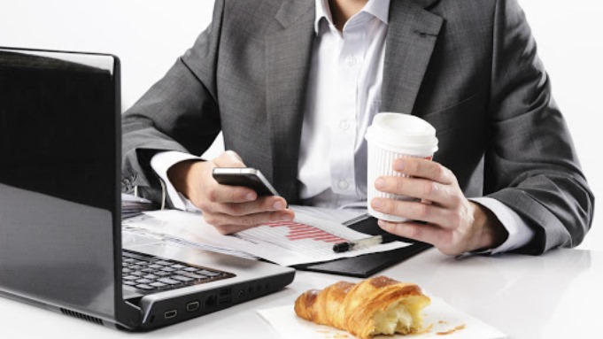 Working breakfast with mobile phone and coffee