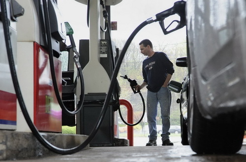 FILE- In this April 28, 2011 file photo, John Magel pumps gas at a station in Wethersfield, Conn. Consumers paid more for gas and food in April, lifting inflation to its highest level in two and a half years. But inflationary pressures have begun to ease in May 2011, and analysts say some prices could taper off by summer. (AP Photo/Jessica Hill, file)