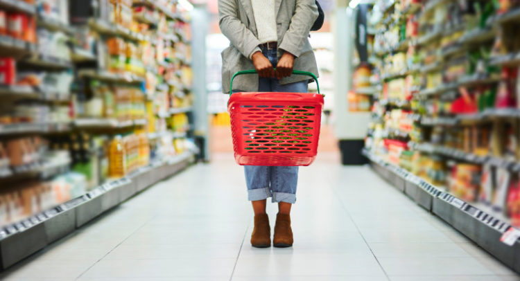 Supermarket aisle, woman legs and basket for shopping in grocery store. Customer, organic grocery shopping and healthy food on groceries sale shelf or eco friendly retail purchase in health shop